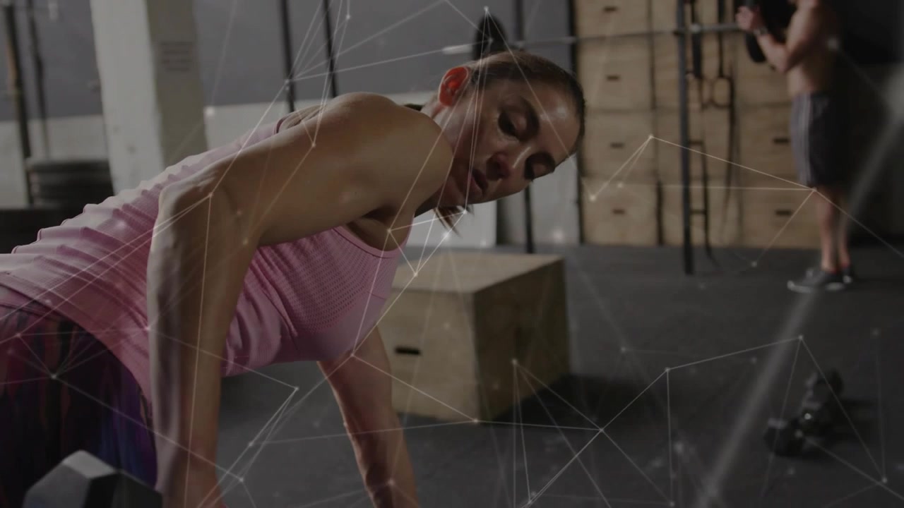 Woman bracing and starting one-arm row with hex dumbbell in gym, mesh overlay showing training form