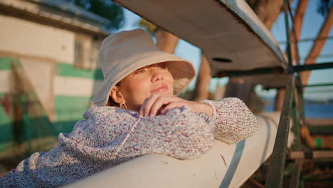 young woman basking sun on summer weekend closeup. smiling model resting lake
