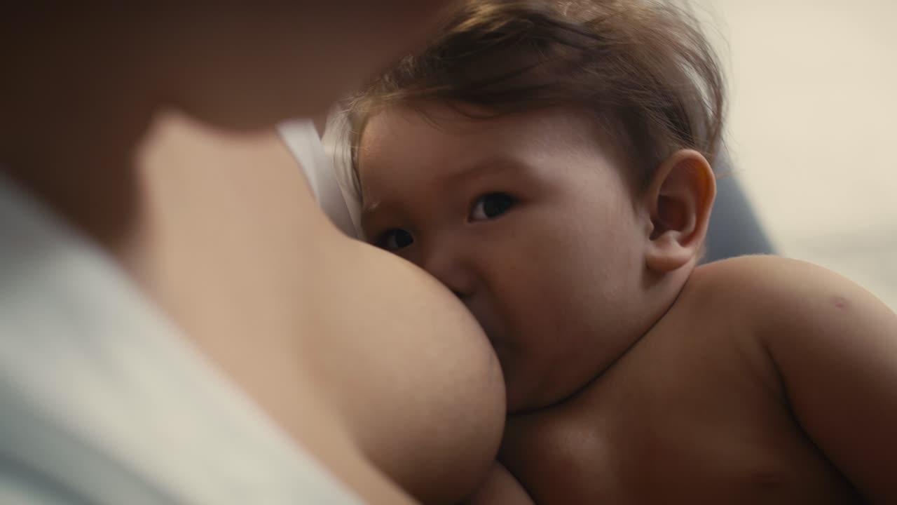 Asian baby breastfed by mother