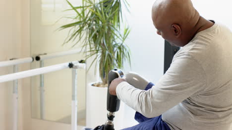 man in prosthetic lab adjusting prosthetic leg, focusing on details