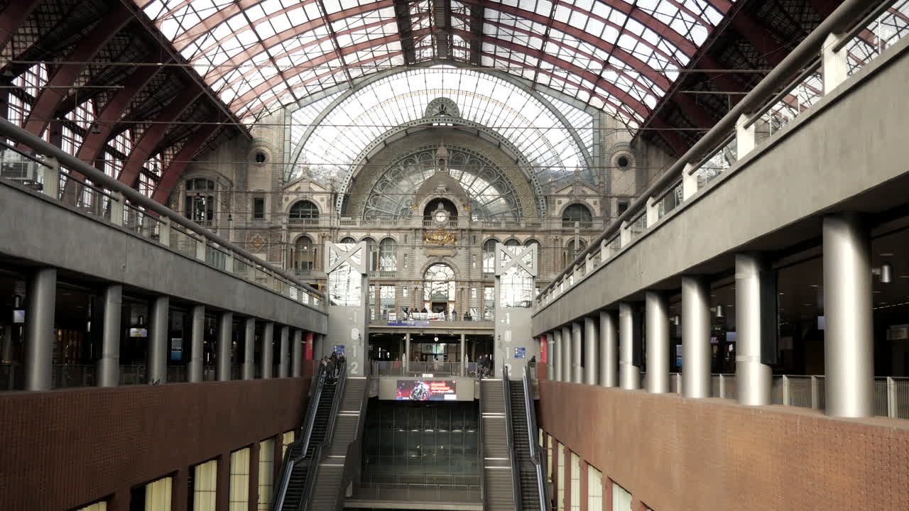 Static wide shot of beautiful central train station with different level tracks and flying pigeons in Antwerp,Belgium