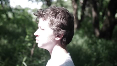 Sad-teenage-boy-walks-through-forest