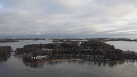 Drone-view-of-island-and-industrial-chimney-smoke-in-background