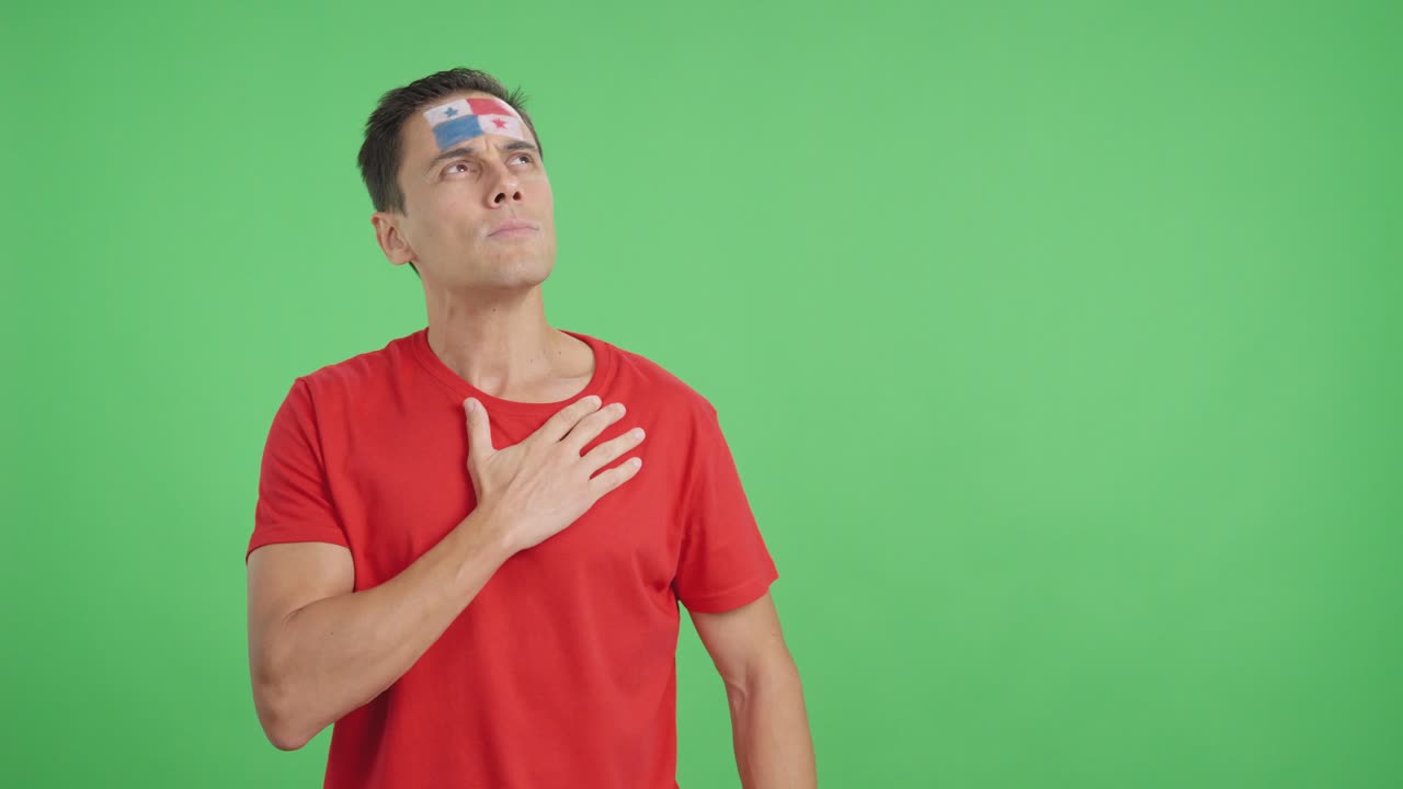 Man listening to the Panama national anthem with solemnity