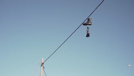 boots hanging on a power line