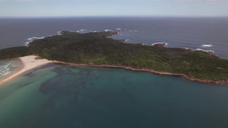 aerial shot over fingal island, fingal bay in new south wales, australia