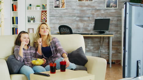 Little-girl-with-braces-sitting-on-the-couch-with-her-mother