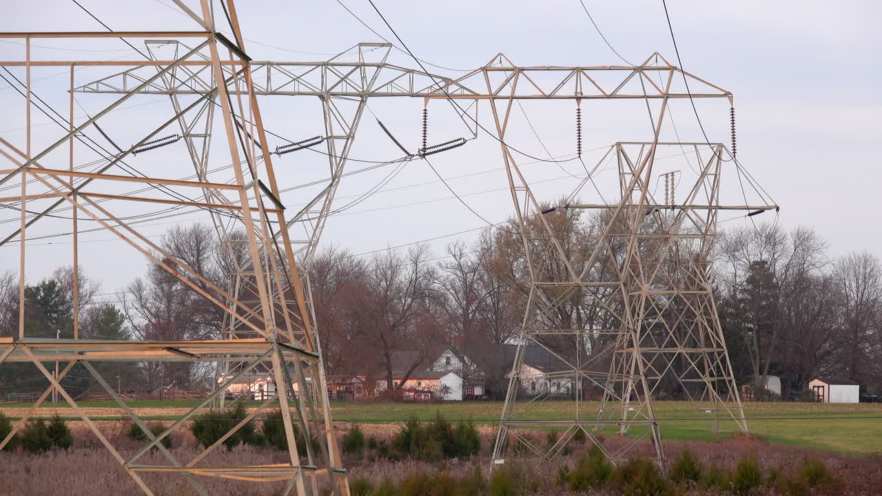 Line of electrical towers across a rural landscape