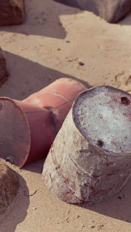 rusty barrels on a beach