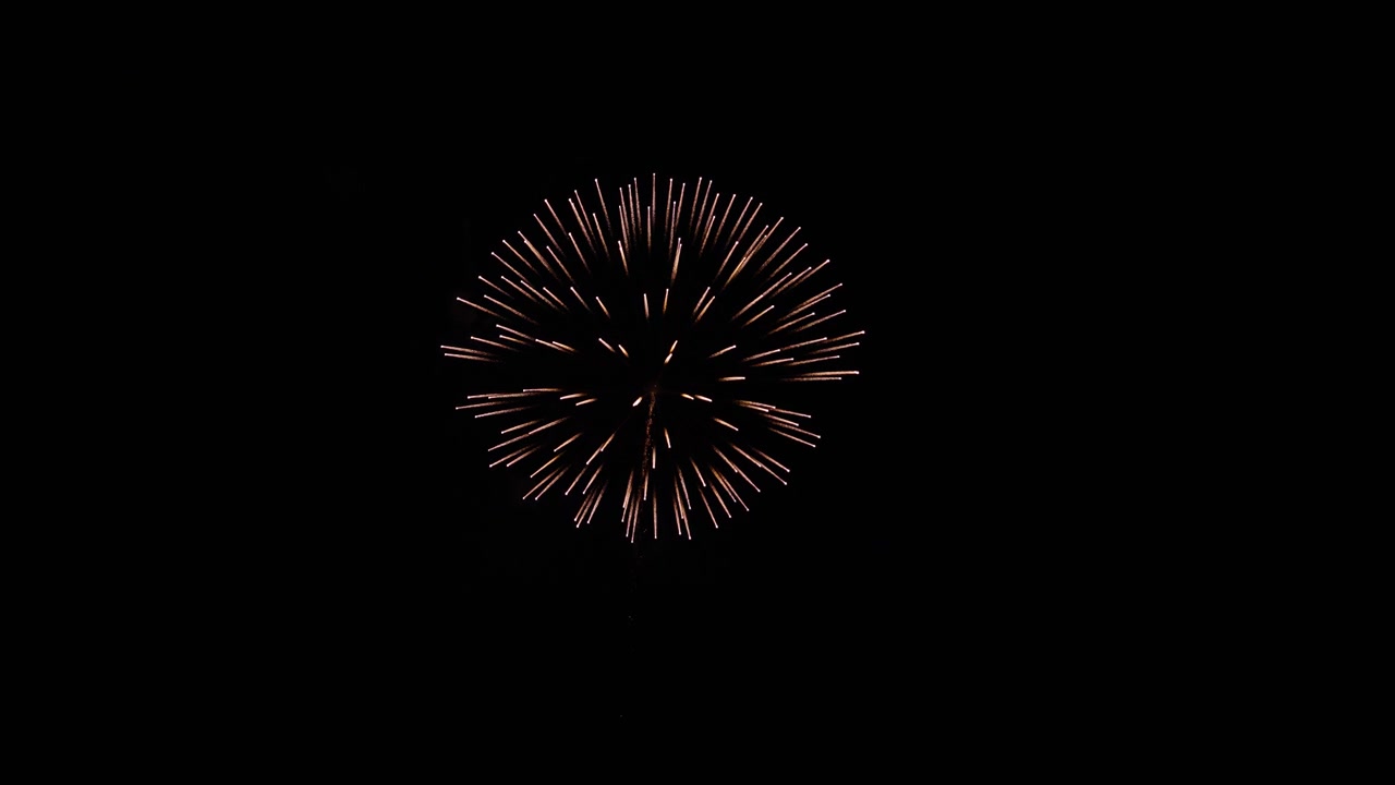 Slow motion wide shot of firework exploding at night during festival celebration