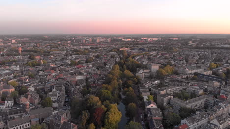 aerial view of the medieval dutch city centre of utrecht following one of its canals at early morning sunrise