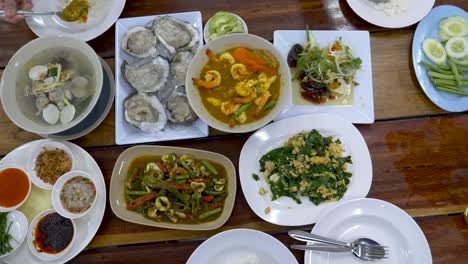 group of people having dinner with thai food-top view on the table