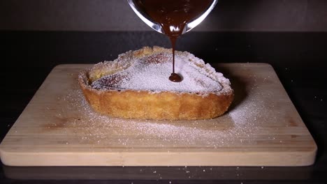 Pouring-chocolate-on-heart-shaped-cheesecake-close-up-shoot