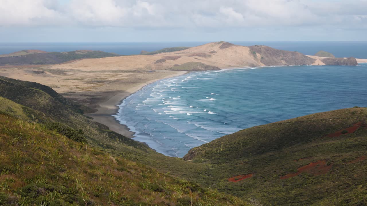 View of beaches, Te Paki giant sand dunes, ocean waves and green coast on a sunny day in Cape Reigna, Northland, New Zealand.