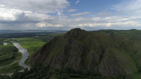 aerial view of a green mountain with a river