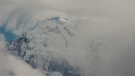majestic snow-covered mountain peak in the clouds
