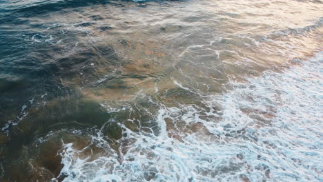 exploring the rocky shoreline structure, unveiling the expansive surface of the atlantic ocean at a beach in portugal