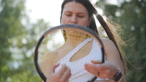 a young woman practicing tennis on an outdoor court with a coach. the coach provides guidance as the player works on her technique, perfecting her strokes in an athletic training session.