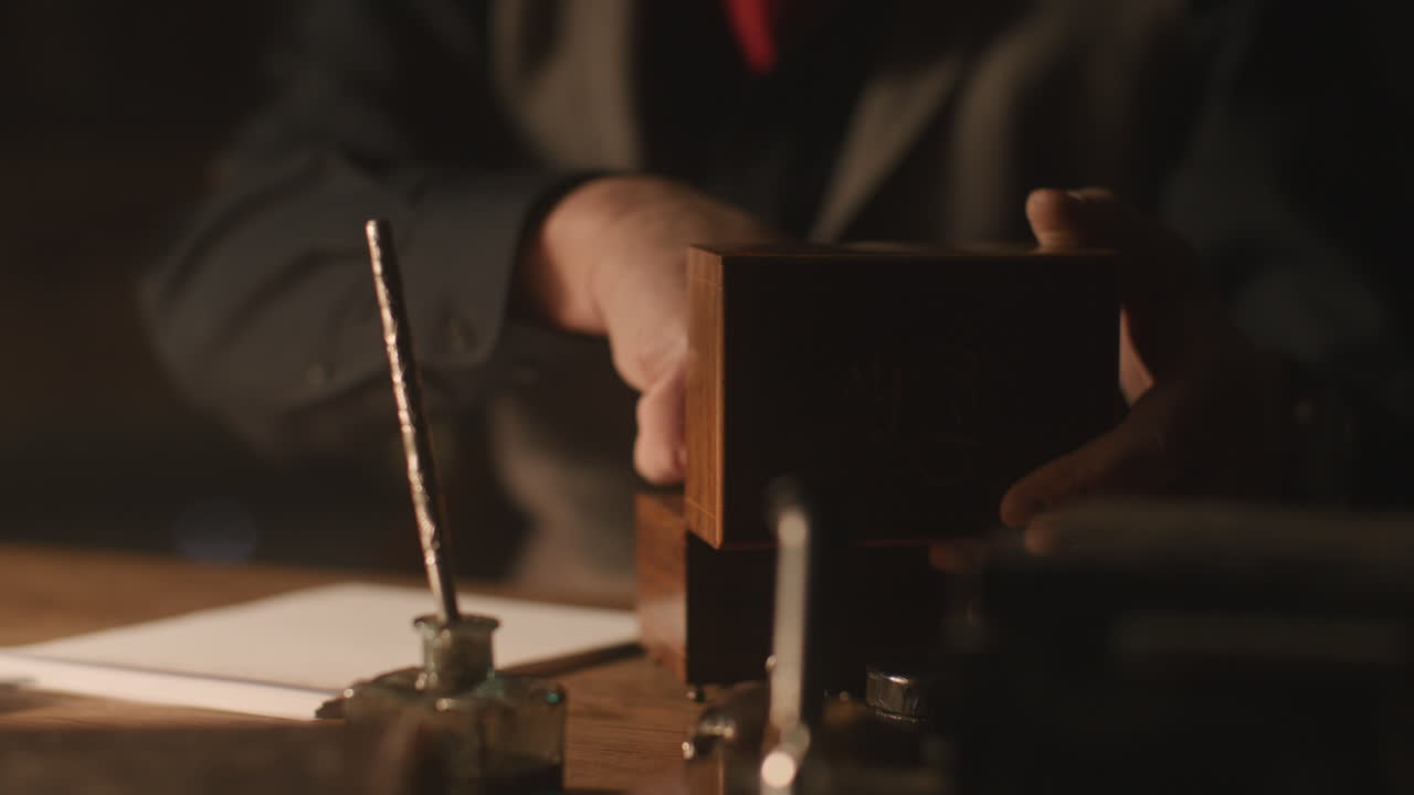 Older passionate man evaluates an old watch in his office at night