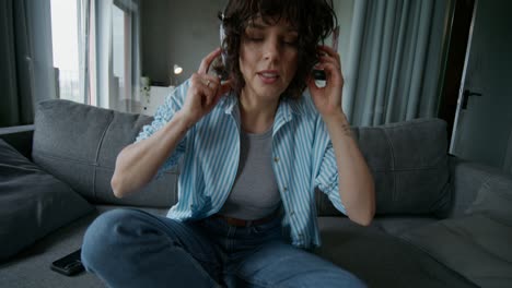 woman listening to music on couch