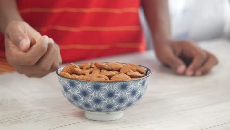 child eating almonds