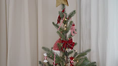 minimalist christmas tree with tartan bow decor and star top