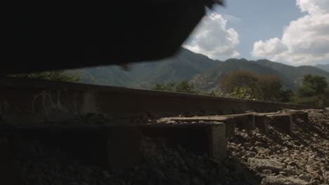 train wheels moving over railroad tracks alongside the country