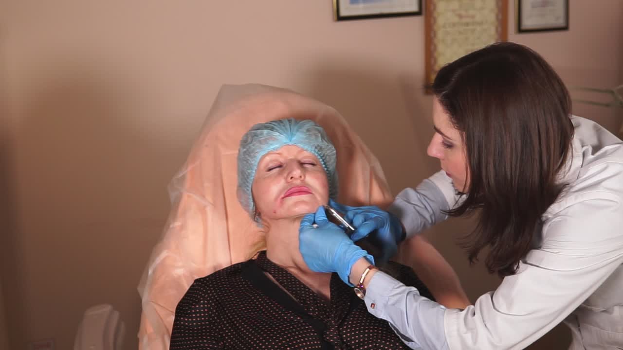 Woman receiving facial injection procedure