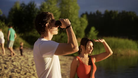 Young-man-and-woman-working-at-the-beach