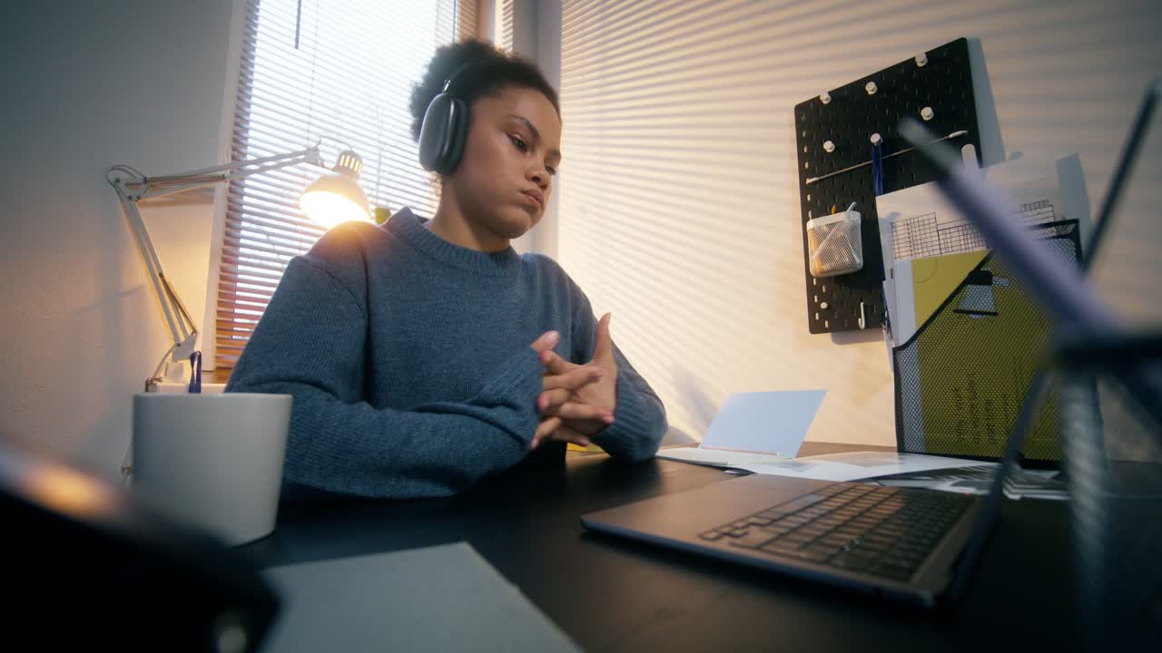 Teenage girl working on a laptop at home