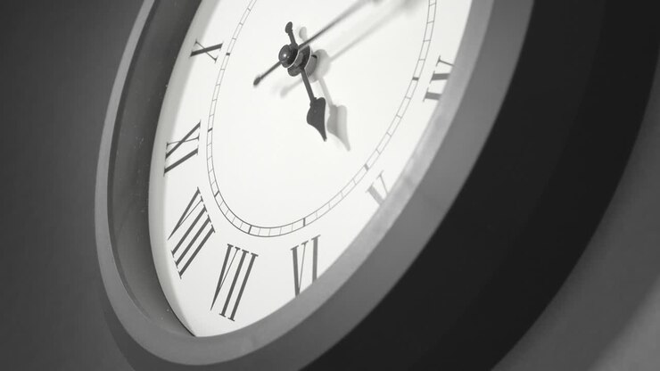 Latin Clock Face in Time Lapse on Dark Grey Wall