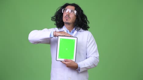 handsome man scientist thinking while showing digital tablet