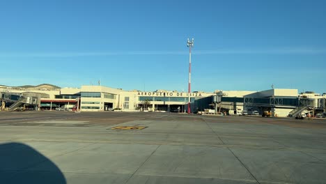 Arriving-to-the-parking-stand-at-Ibiza’s-airport,-Spain,-as-seen-by-the-pilots-with-the-silhouette-of-the-jet-on-the-left-side