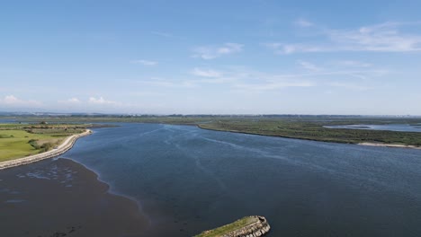 sweeping aerial view of cais do bico beach and estuary, murtosa, aveiro, portugal