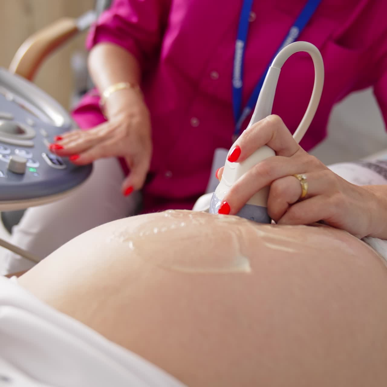 Pregnant woman getting ultrasound screening. Process of fetus ultrasonography. Pregnancy and Healthcare concept
