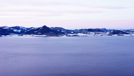 aerial view of calm sea with scenic mountain range in norway