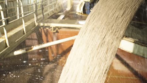 cement clinker from conveyor belt hydrated with water in cement plant. close up