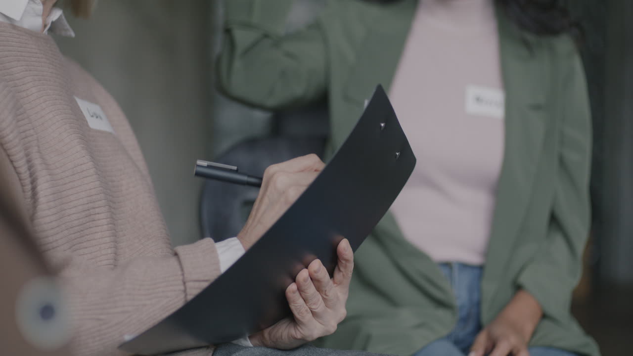 People in a meeting taking notes