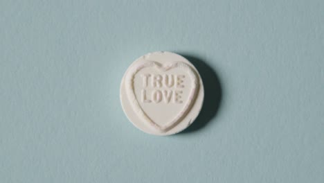 heart candy with true love message on blue background