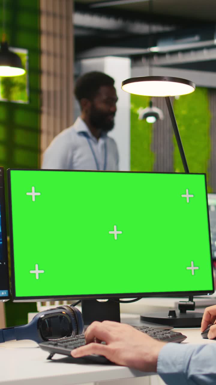 Vertical video Technician in office using green screen PC, automating repetitive tasks with AI