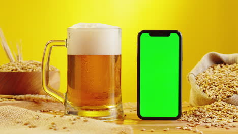 beer and smartphone on wooden table