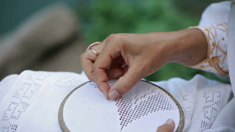 hands woman embroidery pattern. hands of the woman working upon the embroidery