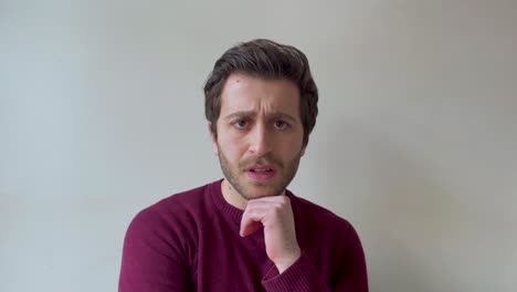 Young-Male-University-Student-Looking-Visibly-Concerned-While-Talking-to-Camera-On-Video-Call