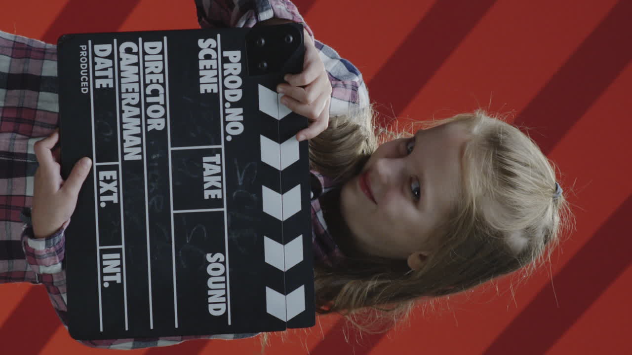 Girl holding a clapperboard