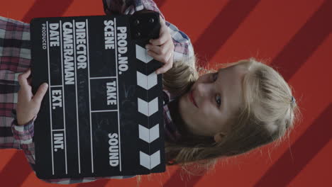 girl holding a clapperboard