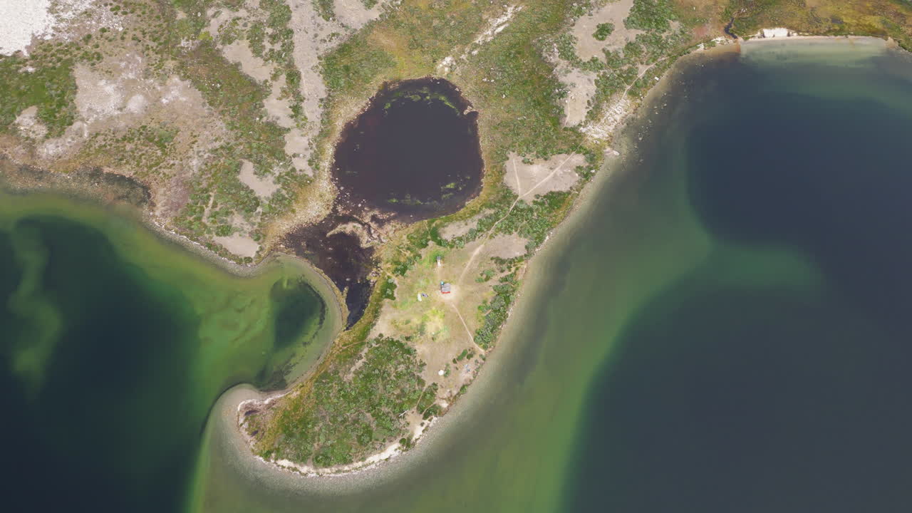 Top down drone shot of land and sea in the day in Greenland, Kingdom of Denmark
