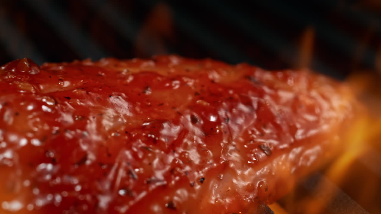 Marinated Chicken Breast Barbecuing On The Charcoal Grill Among Fire Flames in Macro and Slow Motion