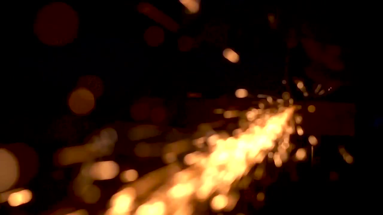 Macro Shot Of Sparks From An Angle Grinder In Black Background - close up
