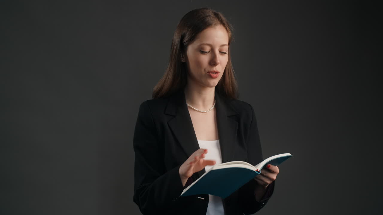 Businesswoman Reading a Notebook