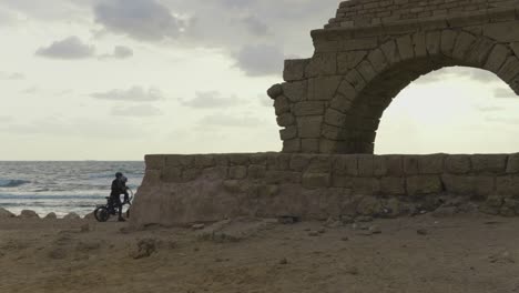 Caesarea-Israel-beach-with-ancient-Roman-ruins-family-walks-along-the-water-on-vacation-in-Jewish-land